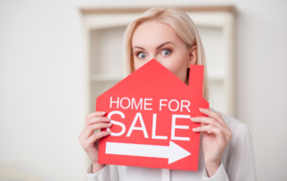 Woman Holding Red Home For Sale Sign with Arrow || Sell Your House